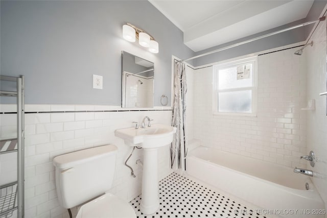 1232 S Gary Pl, Tulsa, OK 74104 - bathroom featuring shower / bathtub combination with curtain, toilet, tile walls, and a wainscoted wall