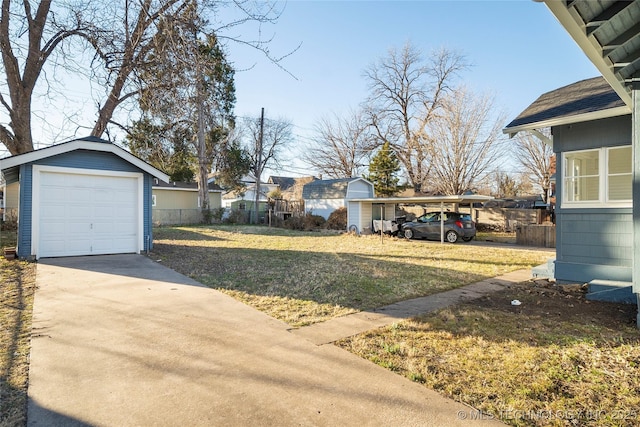 1232 S Gary Pl, Tulsa, OK 74104 - view of yard featuring an outdoor structure, a garage, and driveway