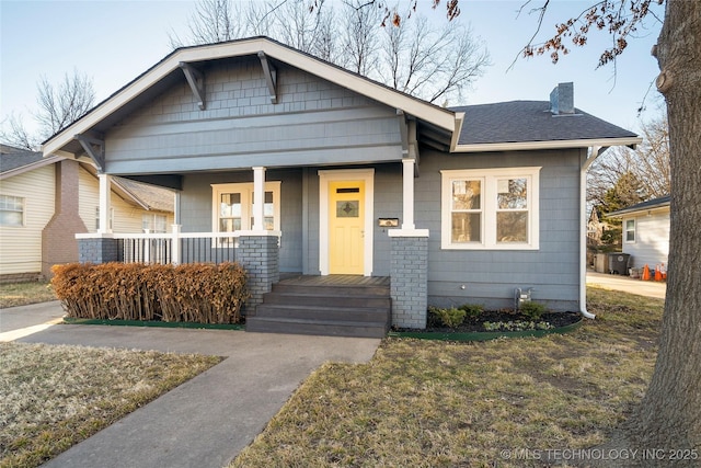 1232 S Gary Pl, Tulsa, OK 74104 - bungalow-style house featuring a chimney, covered porch, and roof with shingles