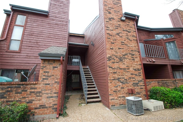 6737 S Peoria Ave Unit C213, Tulsa, OK 74136 - view of property with cooling unit and stairway