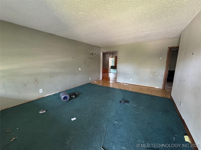 10653 E 18th St, Tulsa, OK 74128 - empty room featuring a textured ceiling and carpet flooring