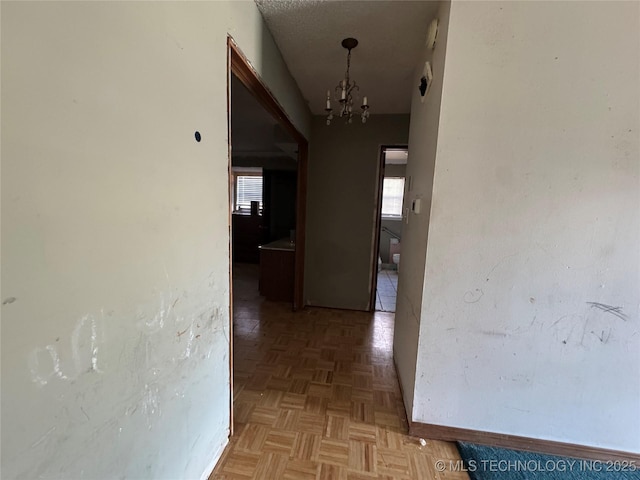 10653 E 18th St, Tulsa, OK 74128 - corridor featuring a chandelier and baseboards