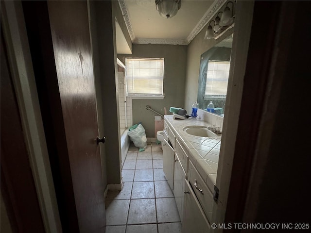 10653 E 18th St, Tulsa, OK 74128 - full bath with vanity, crown molding, toilet, shower / washtub combination, and tile patterned floors