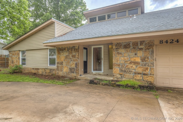8424 Harp Blvd, Broken Arrow, OK 74014 - view of front of house featuring stone siding, roof with shingles, and a garage