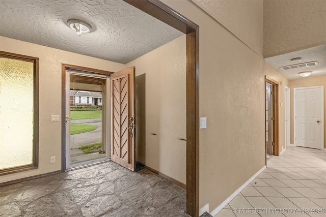 8424 Harp Blvd, Broken Arrow, OK 74014 - entryway with a textured ceiling, baseboards, and a textured wall