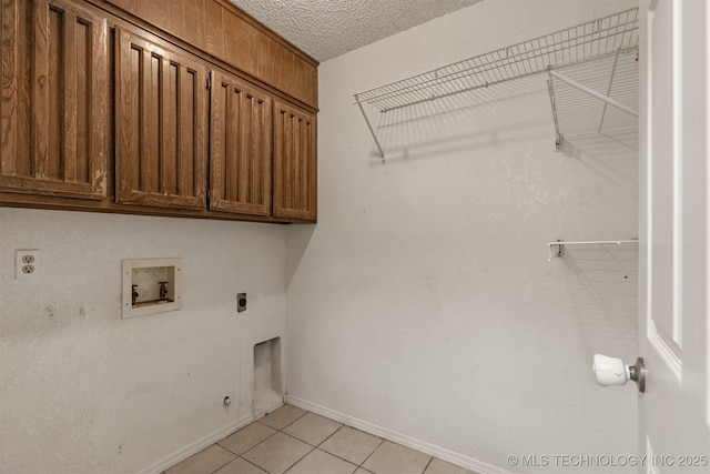 8424 Harp Blvd, Broken Arrow, OK 74014 - laundry area featuring cabinet space, washer hookup, electric dryer hookup, baseboards, and light tile patterned flooring