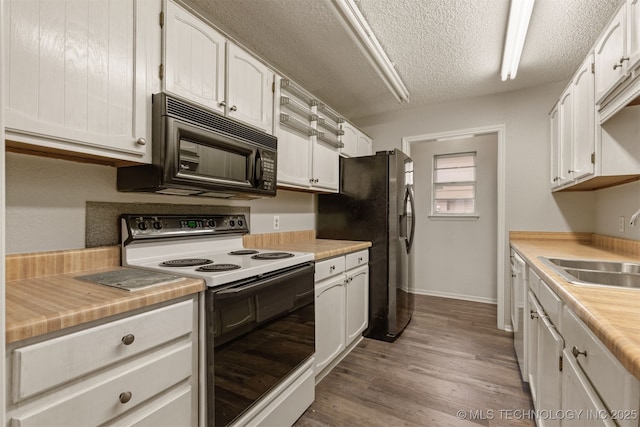 4012 S Cedar Ave, Broken Arrow, OK 74011 - kitchen with electric stove, black microwave, a sink, light countertops, and a textured ceiling