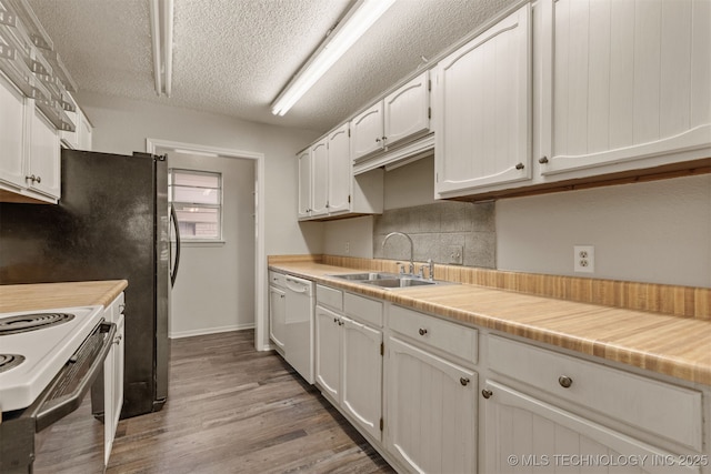 4012 S Cedar Ave, Broken Arrow, OK 74011 - kitchen with a sink, white appliances, light wood finished floors, tasteful backsplash, and a textured ceiling