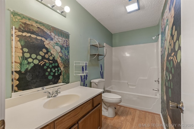 4012 S Cedar Ave, Broken Arrow, OK 74011 - full bathroom with a textured ceiling, wood finished floors, vanity, toilet, and bathing tub / shower combination