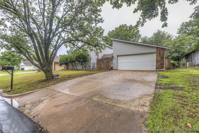 4012 S Cedar Ave, Broken Arrow, OK 74011 - view of front facade featuring a garage, a front lawn, cooling unit, and concrete driveway