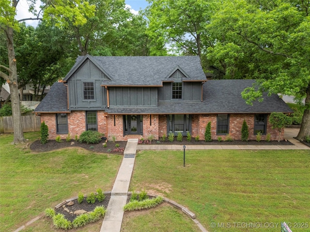 7802 S Joplin Ave, Tulsa, OK 74136 - view of front facade featuring roof with shingles, brick siding, and board and batten siding