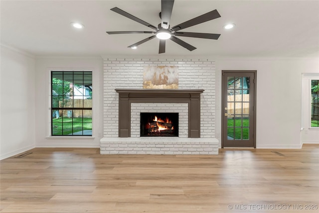 7802 S Joplin Ave, Tulsa, OK 74136 - unfurnished living room with crown molding, wood finished floors, healthy amount of natural light, a fireplace, and recessed lighting