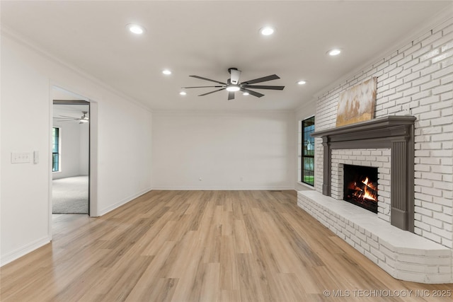 7802 S Joplin Ave, Tulsa, OK 74136 - unfurnished living room with a ceiling fan, recessed lighting, ornamental molding, a brick fireplace, and light wood-style floors