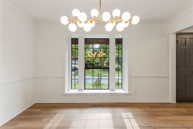 7802 S Joplin Ave, Tulsa, OK 74136 - unfurnished dining area with a chandelier, wood finished floors, ornamental molding, and baseboards
