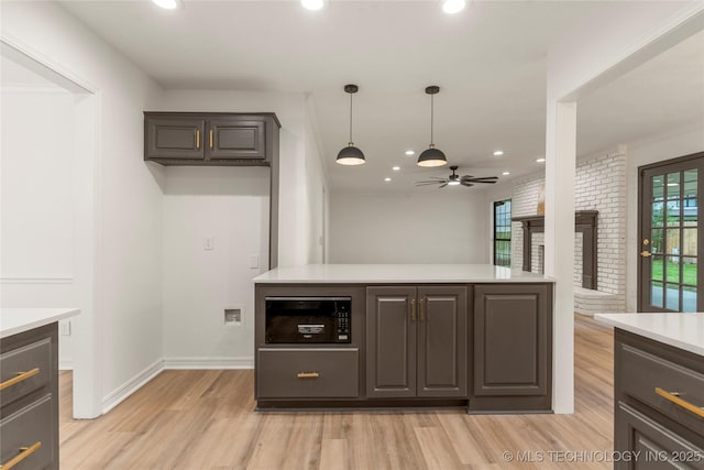 7802 S Joplin Ave, Tulsa, OK 74136 - kitchen featuring ceiling fan, light countertops, light wood finished floors, a fireplace, and recessed lighting