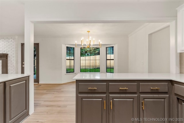 7802 S Joplin Ave, Tulsa, OK 74136 - kitchen featuring a chandelier, light countertops, light wood-style flooring, crown molding, and baseboards