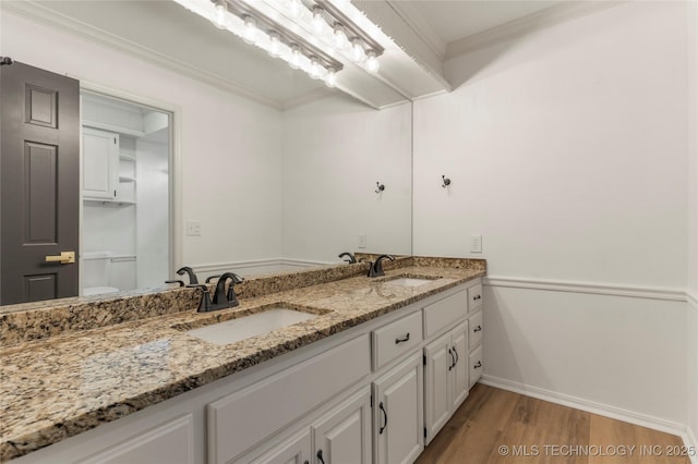 7802 S Joplin Ave, Tulsa, OK 74136 - bathroom with double vanity, wood finished floors, crown molding, baseboards, and toilet