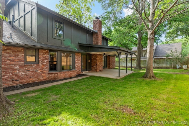 7802 S Joplin Ave, Tulsa, OK 74136 - rear view of house with a patio, a chimney, board and batten siding, brick siding, and a ceiling fan
