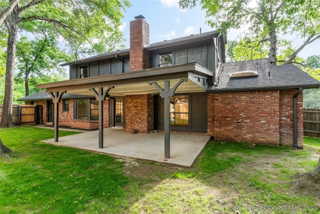 7802 S Joplin Ave, Tulsa, OK 74136 - back of house featuring a chimney, a patio, and brick siding