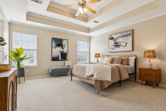 12326 S Cedar Ave, Jenks, OK 74037 - bedroom featuring crown molding, multiple windows, a tray ceiling, and light colored carpet
