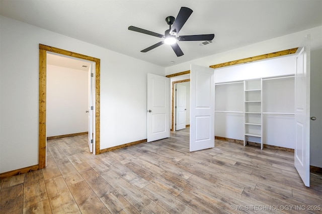 984 Ridgepoint, Fort Towson, OK 74735 - unfurnished bedroom with wood finished floors, a ceiling fan, and baseboards