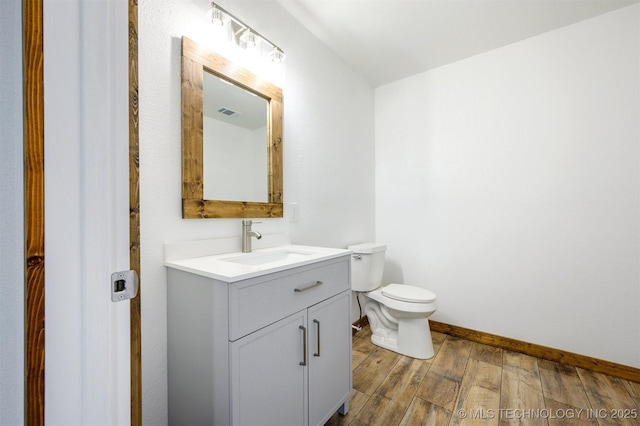 984 Ridgepoint, Fort Towson, OK 74735 - bathroom featuring vanity, toilet, wood finished floors, and baseboards