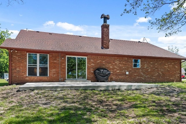 1510 Bowden Pl, Fort Gibson, OK 74434 - back of property featuring a chimney, a patio, brick siding, and a shingled roof