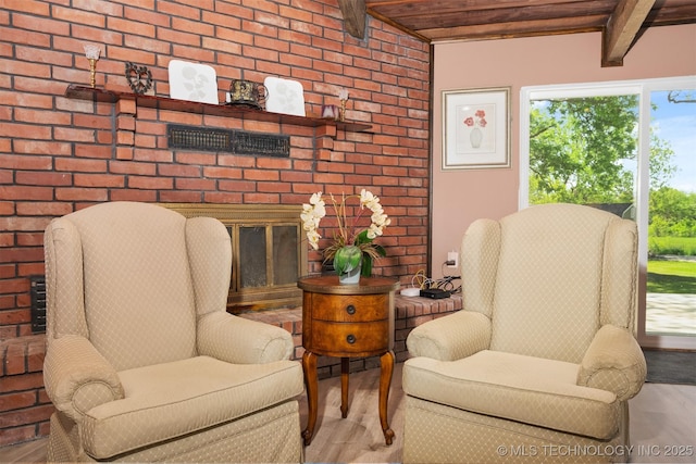 1510 Bowden Pl, Fort Gibson, OK 74434 - living area featuring wooden ceiling with exposed beams, wood finished floors, a fireplace, and brick wall