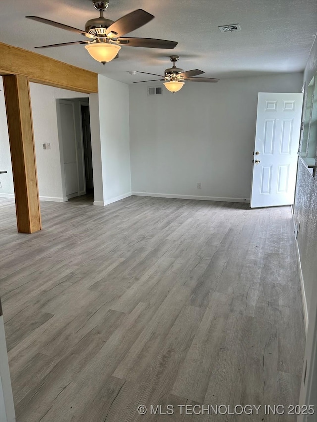 4613 N Main St E, Tulsa, OK 74115 - unfurnished living room with a ceiling fan, wood finished floors, and baseboards