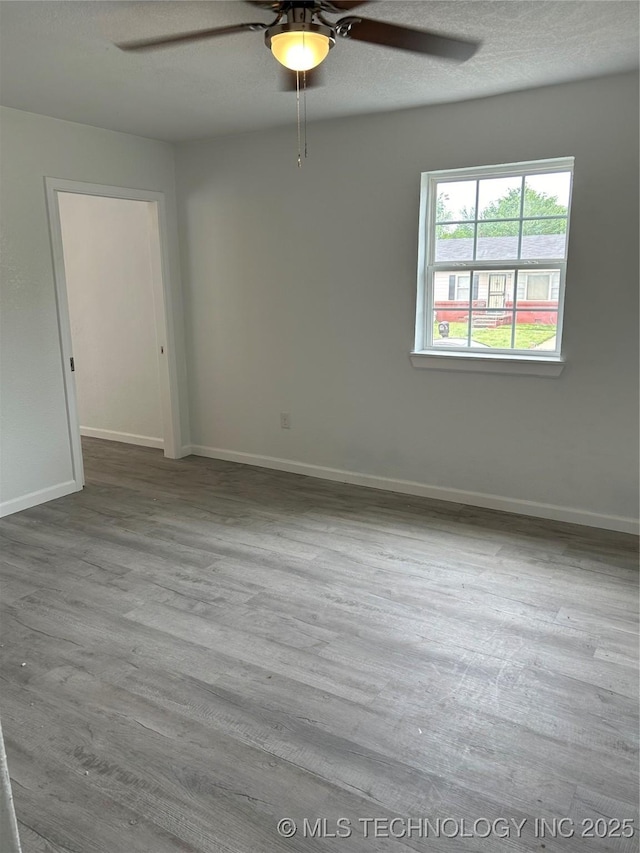 4613 N Main St E, Tulsa, OK 74115 - unfurnished room with ceiling fan, baseboards, and wood finished floors