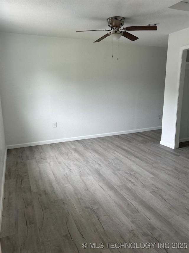 4613 N Main St E, Tulsa, OK 74115 - spare room featuring wood finished floors, ceiling fan, and baseboards