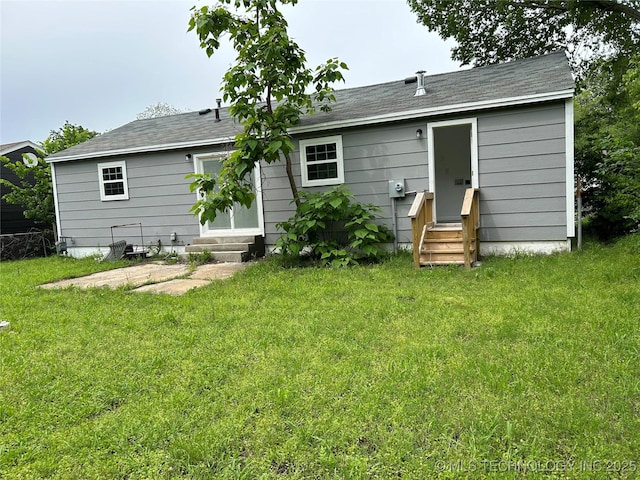 4613 N Main St E, Tulsa, OK 74115 - rear view of house featuring entry steps and a lawn