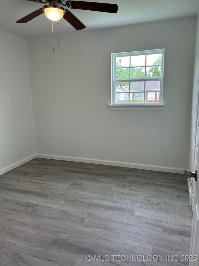 4613 N Main St E, Tulsa, OK 74115 - spare room with ceiling fan, wood finished floors, and baseboards