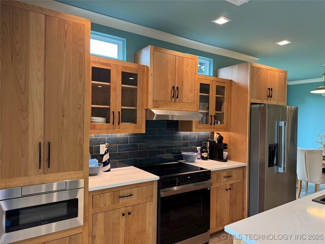 659 Sleepy Hollow Ln, Cleveland, OK 74020 - kitchen with stainless steel appliances, tasteful backsplash, light countertops, exhaust hood, and crown molding