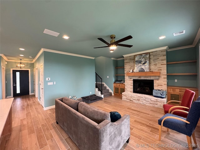 659 Sleepy Hollow Ln, Cleveland, OK 74020 - living room featuring crown molding, wood finished floors, ceiling fan, baseboards, and stairway