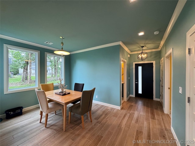 659 Sleepy Hollow Ln, Cleveland, OK 74020 - dining space with wood finished floors, baseboards, a chandelier, and ornamental molding