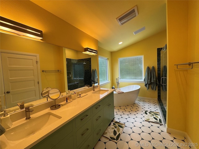 659 Sleepy Hollow Ln, Cleveland, OK 74020 - full bath featuring tile patterned floors, lofted ceiling, a shower stall, double vanity, and a freestanding tub