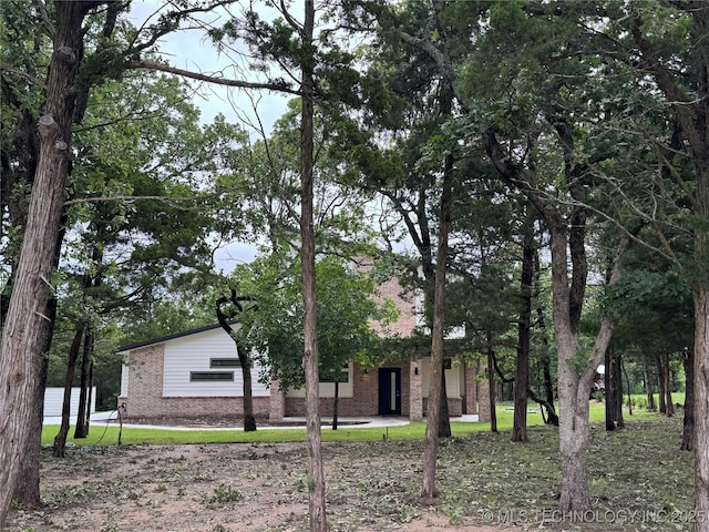 659 Sleepy Hollow Ln, Cleveland, OK 74020 - obstructed view of property featuring brick siding