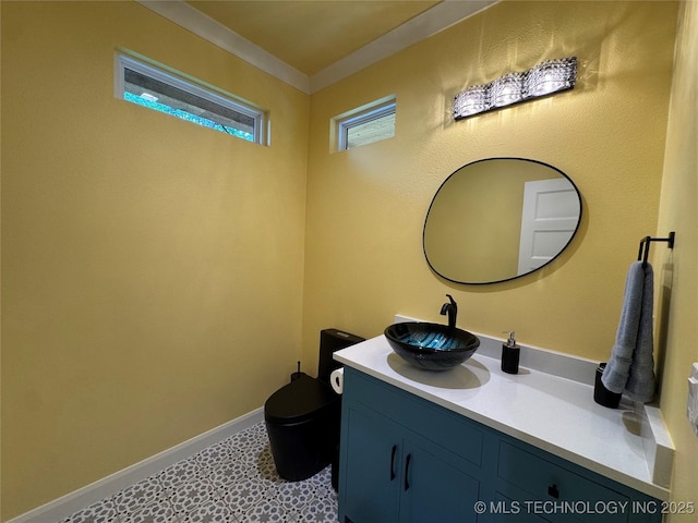 659 Sleepy Hollow Ln, Cleveland, OK 74020 - bathroom with vanity, toilet, tile patterned floors, crown molding, and baseboards