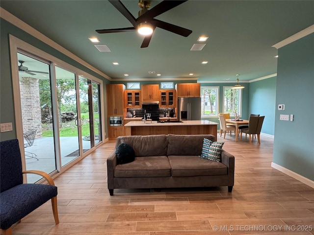 659 Sleepy Hollow Ln, Cleveland, OK 74020 - living room featuring ceiling fan, crown molding, light wood-type flooring, baseboards, and recessed lighting