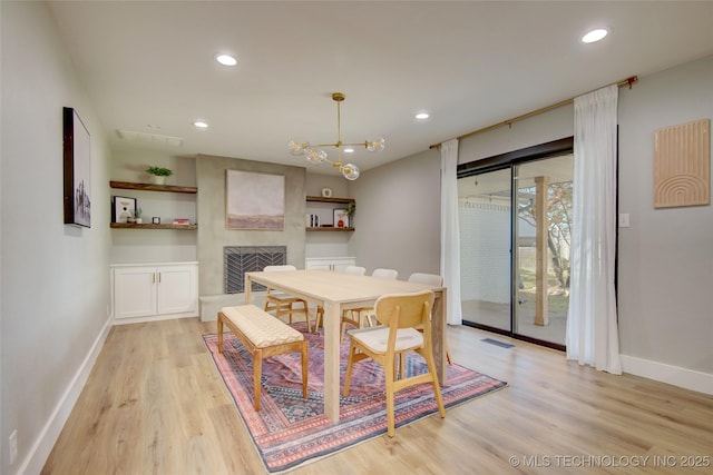 5132 S Atlanta Ave, Tulsa, OK 74105 - dining space featuring light wood-type flooring, baseboards, a large fireplace, recessed lighting, and a chandelier