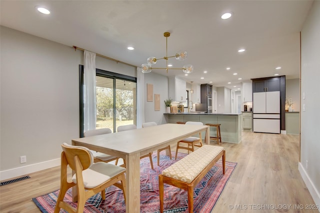 5132 S Atlanta Ave, Tulsa, OK 74105 - dining space with baseboards, light wood-type flooring, recessed lighting, and a chandelier