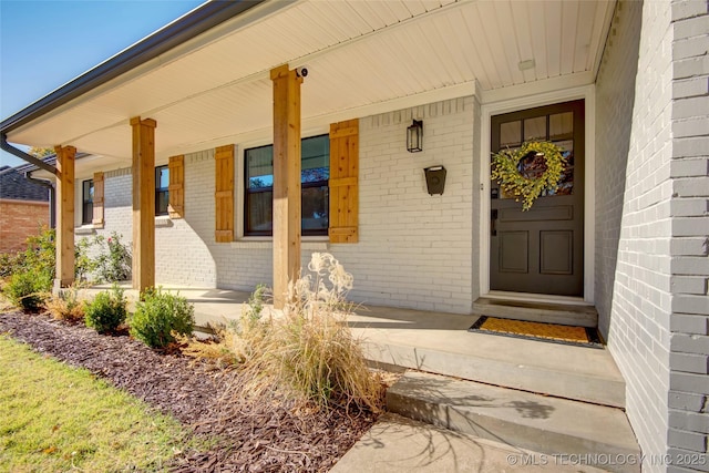 5132 S Atlanta Ave, Tulsa, OK 74105 - property entrance featuring brick siding, a porch, and a surveillance system