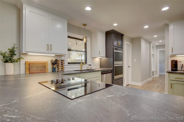5132 S Atlanta Ave, Tulsa, OK 74105 - kitchen with a sink, appliances with stainless steel finishes, tasteful backsplash, recessed lighting, and light wood-style flooring