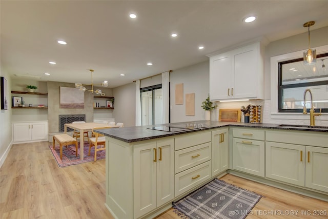 5132 S Atlanta Ave, Tulsa, OK 74105 - kitchen with a sink, black electric stovetop, light wood-type flooring, pendant lighting, and recessed lighting