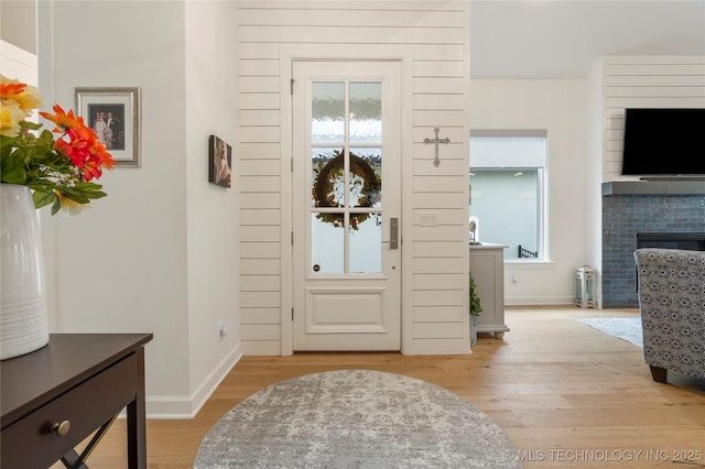 1228 W 85th Ct S, Tulsa, OK 74132 - entrance foyer featuring light wood-style flooring and a brick fireplace