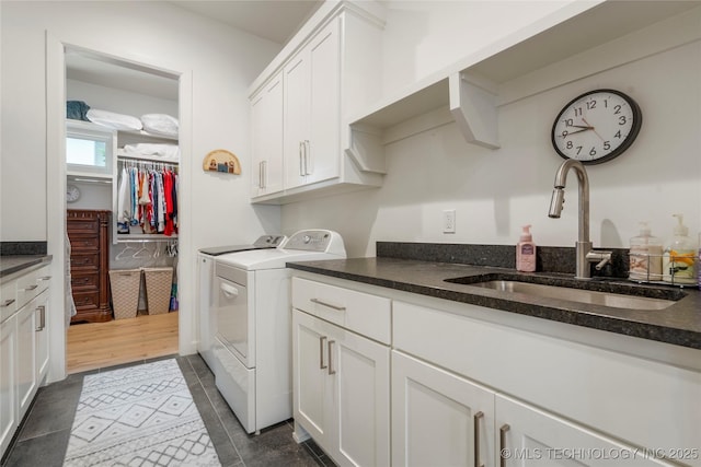 1228 W 85th Ct S, Tulsa, OK 74132 - laundry area featuring cabinet space, washing machine and clothes dryer, and dark tile patterned flooring