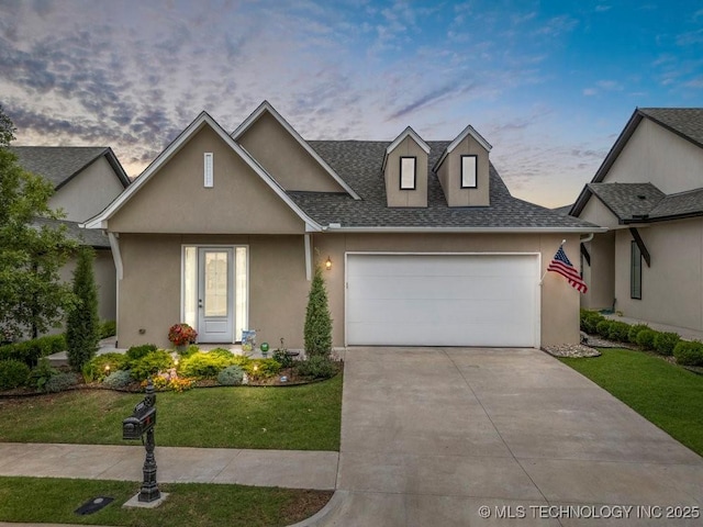1228 W 85th Ct S, Tulsa, OK 74132 - view of front of property featuring an attached garage, driveway, a lawn, stucco siding, and a shingled roof
