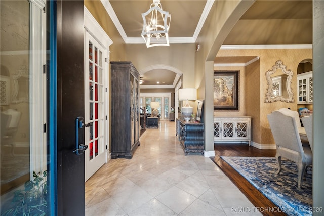 6317 E 110th St, Tulsa, OK 74137 - entrance foyer with arched walkways, crown molding, baseboards, french doors, and a chandelier