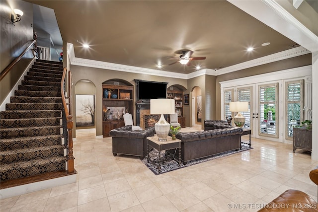 6317 E 110th St, Tulsa, OK 74137 - tiled living room featuring ceiling fan, crown molding, arched walkways, stairway, and french doors